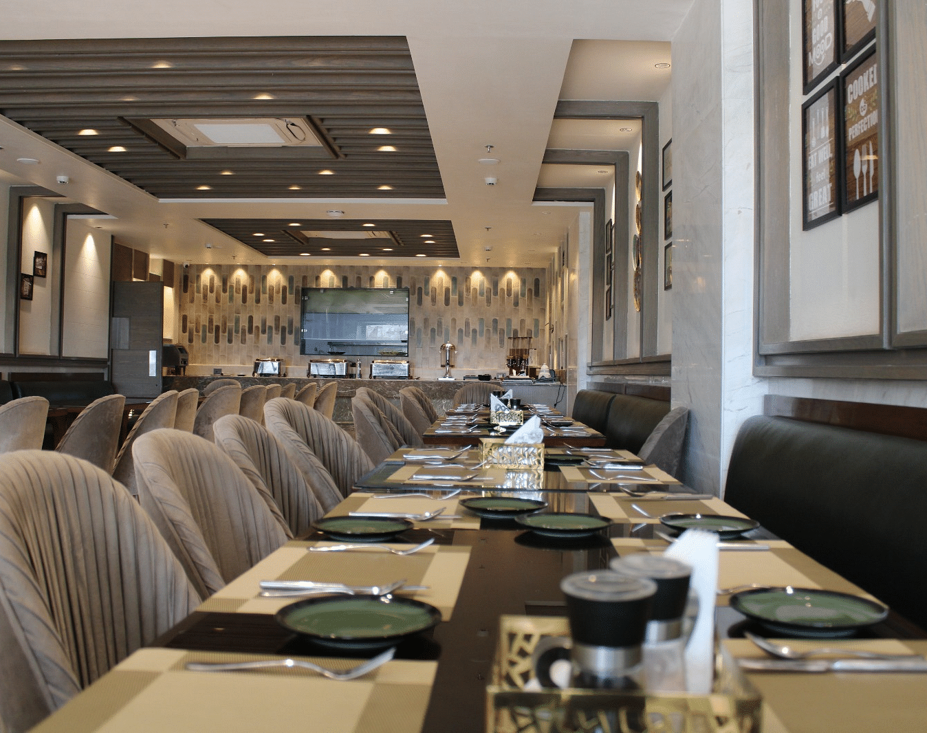 A well-arranged dining space featuring tables with chairs and neatly set cutlery at  BluSalzz Residence, Amritsar